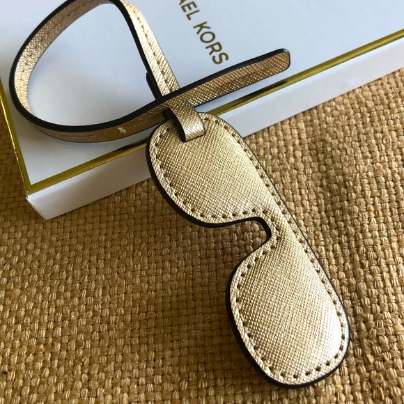 Michael Kors gold leather sunglasses bag charm.